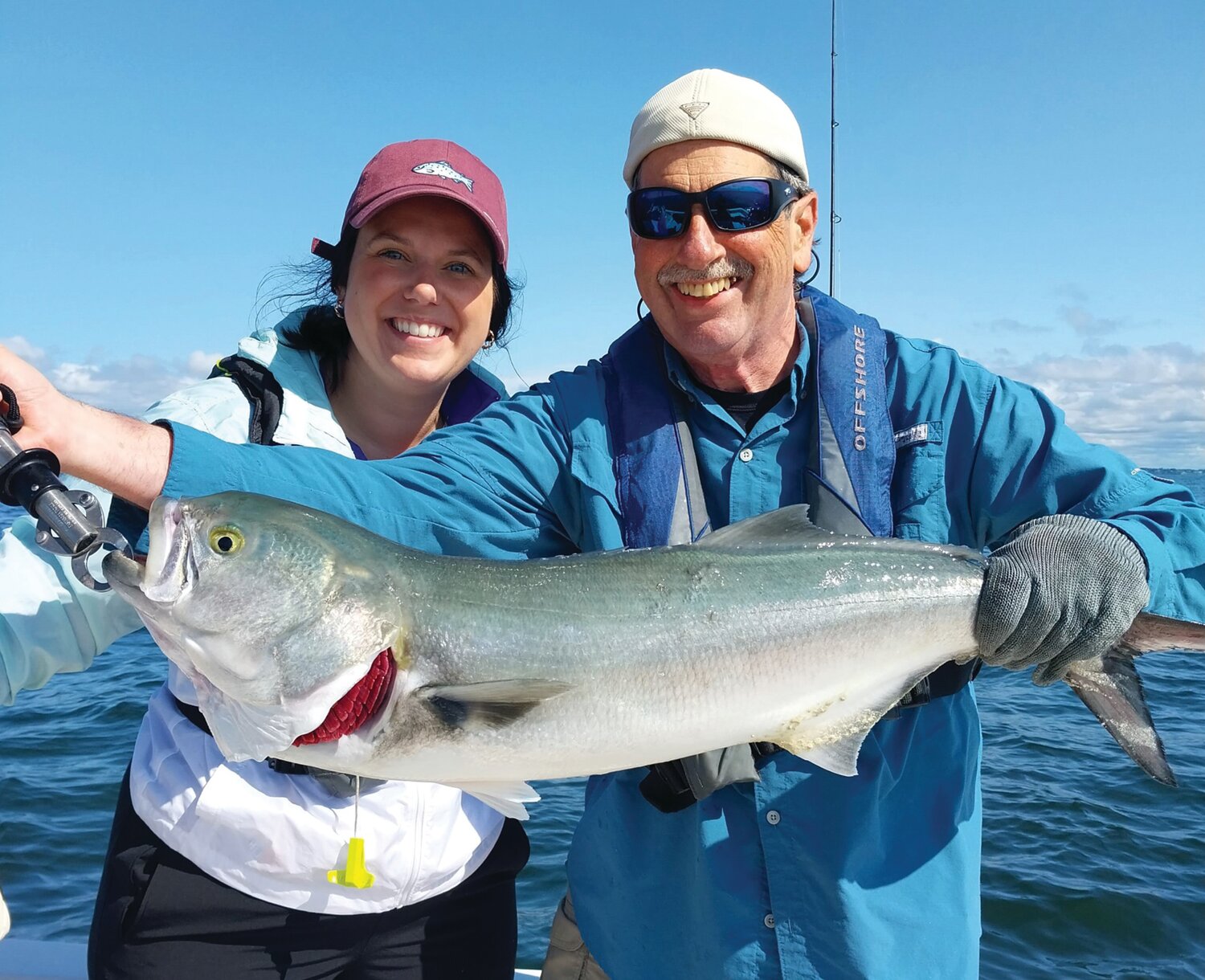 GATOR BLUEFISH: Shaina Boyle of Smithfield caught this 36-inch bluefish when fishing with father Gary Vandemoortele. Capt. Dave Monti holds fish.